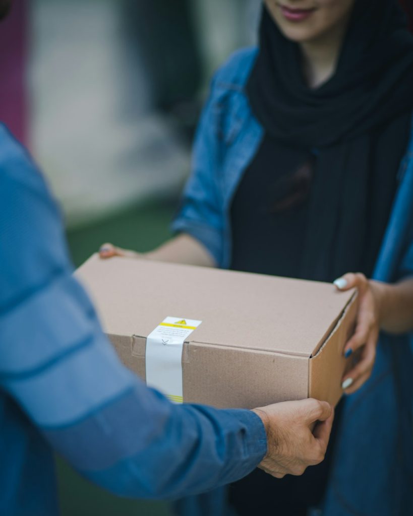 Hand delivering an online store order in a brown box