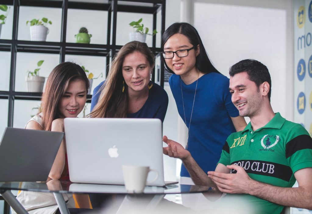 Team reviewing a website build on a laptop