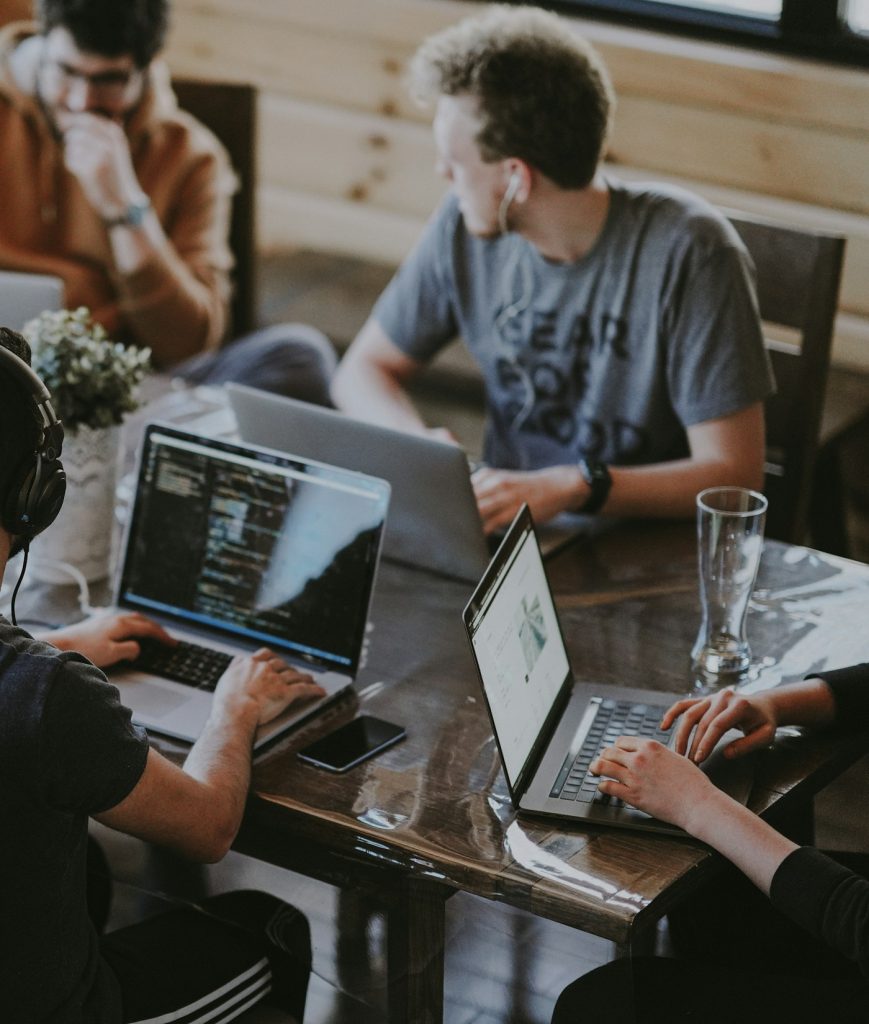 Team planning a website project around a laptop