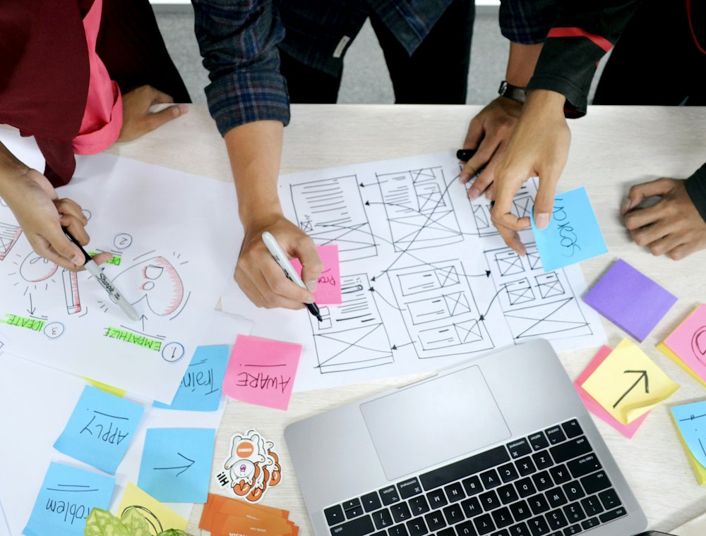 Designer sketching website wireframes on paper